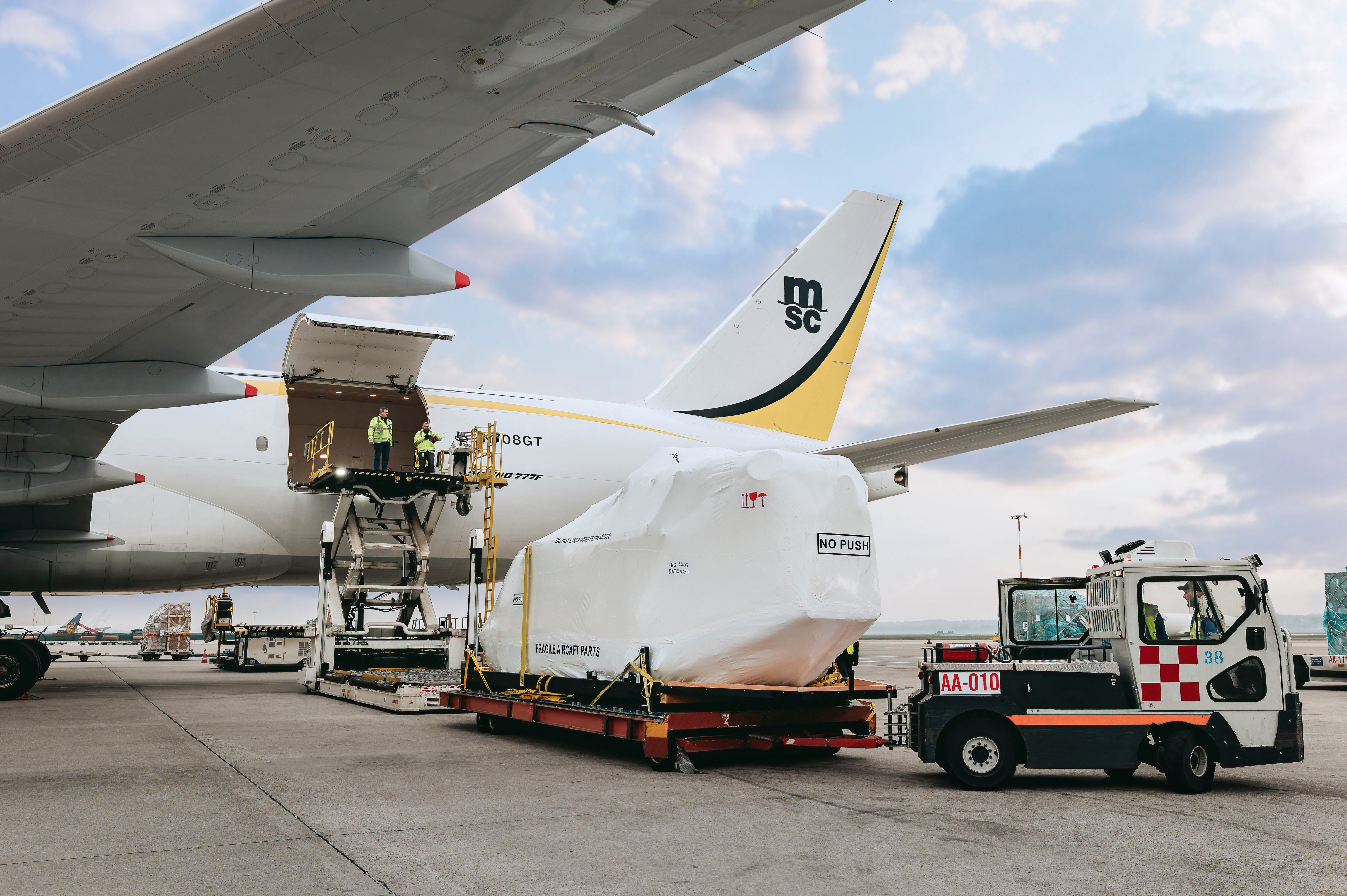 Helicopter shipment being prepared and secured for air transport aboard MSC Air Cargo company cargo aircraft