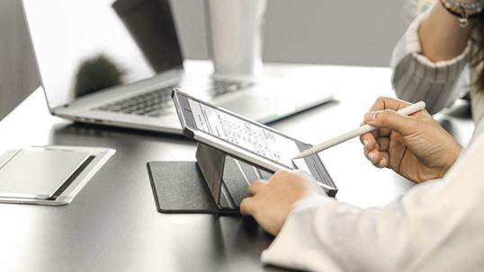 people working on a tablet - only hands showing
