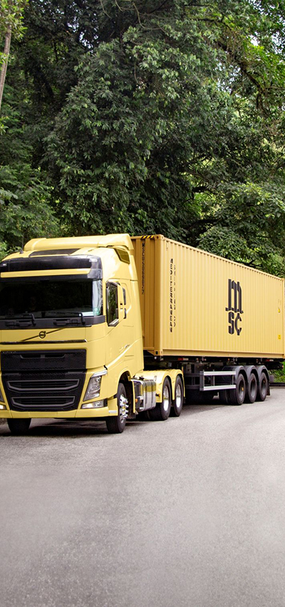 Yellow truck carrying MSC dry container