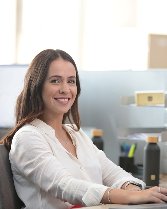 MSC woman employee on her desk looking at the camera