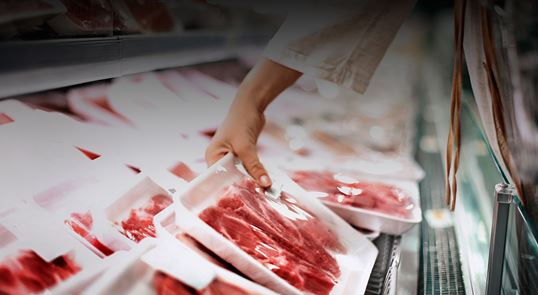 person buying meat at grocery store