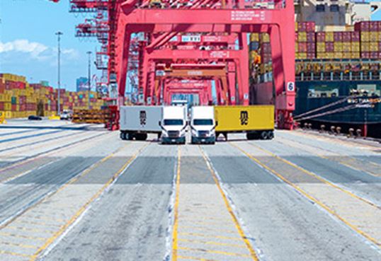 MSC trucks with dry and reefer containers at terminal