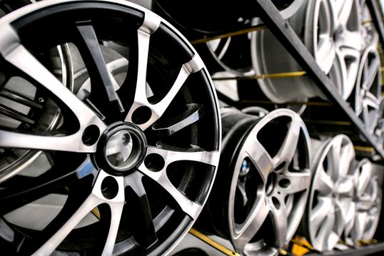 Automotive alloy wheels stacked in rows, representing MSC’s specialist logistics solutions for car parts and components.
