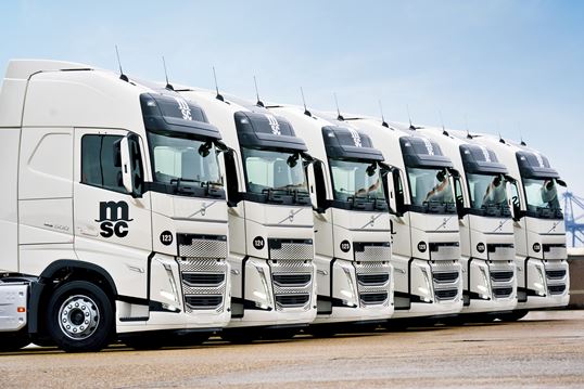 Fleet of white haulage trucks ready for intermodal transport within the MSC logistics network