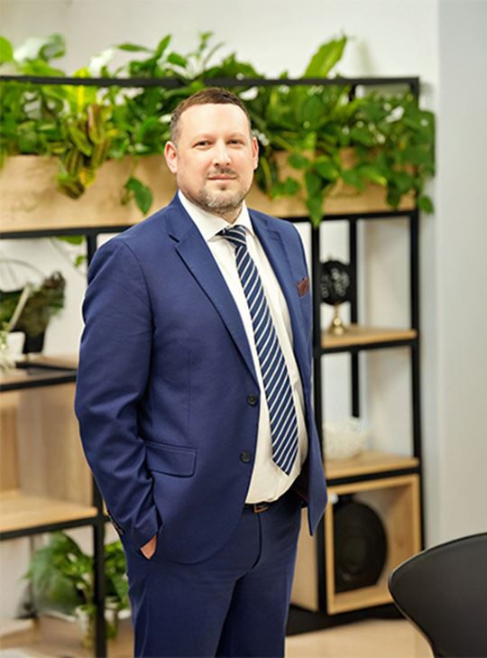 Professional in business attire standing in an office, representing MSC’s Far East export trade management.