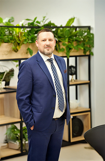 Professional in business attire standing in an office, representing MSC’s Far East export trade management.