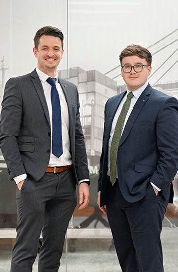 Professionals in business attire standing in an office, representing MSC’s Far East import trade management.