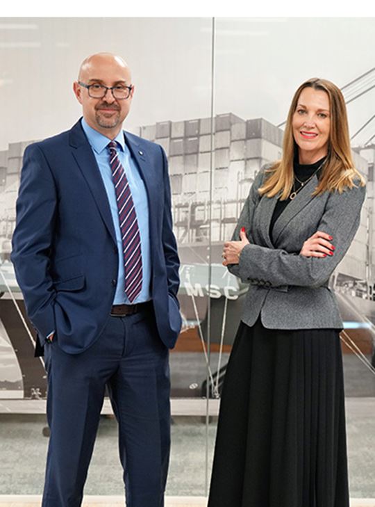 Professionals in business attire standing in an office, representing MSC’s Transatlantic export trade management.