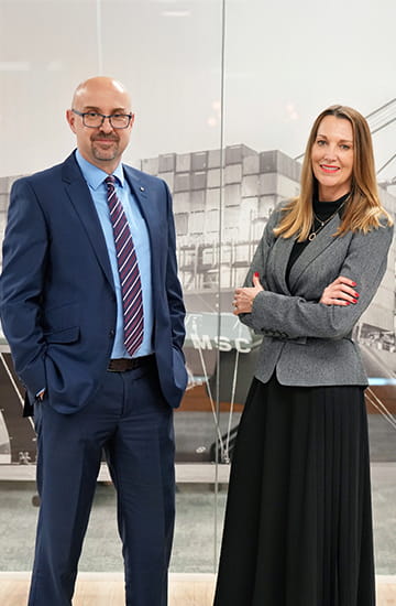 Professional in business attire standing in an office, representing MSC’s Transatlantic import trade management.