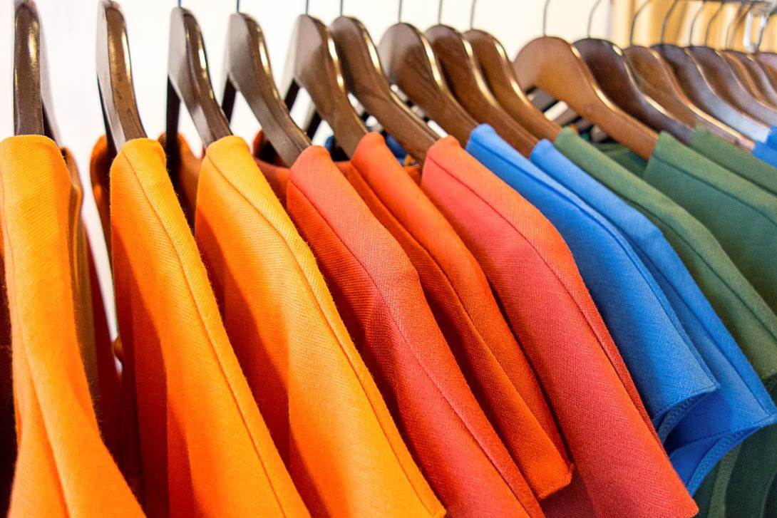 colorful t-shirts hanging on hangers