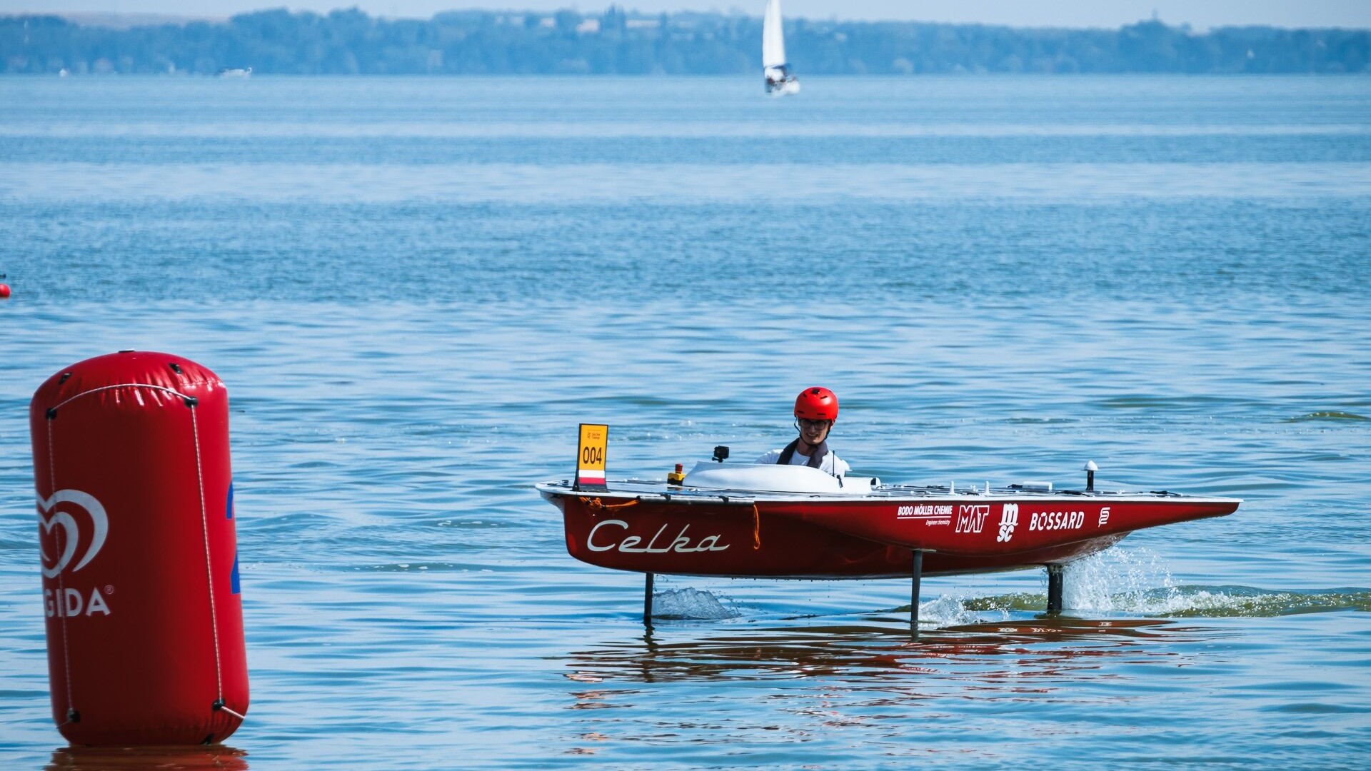 man on solar boat wearing red helmet