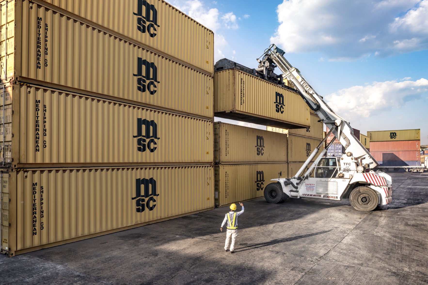 Dry container being moved by a crane