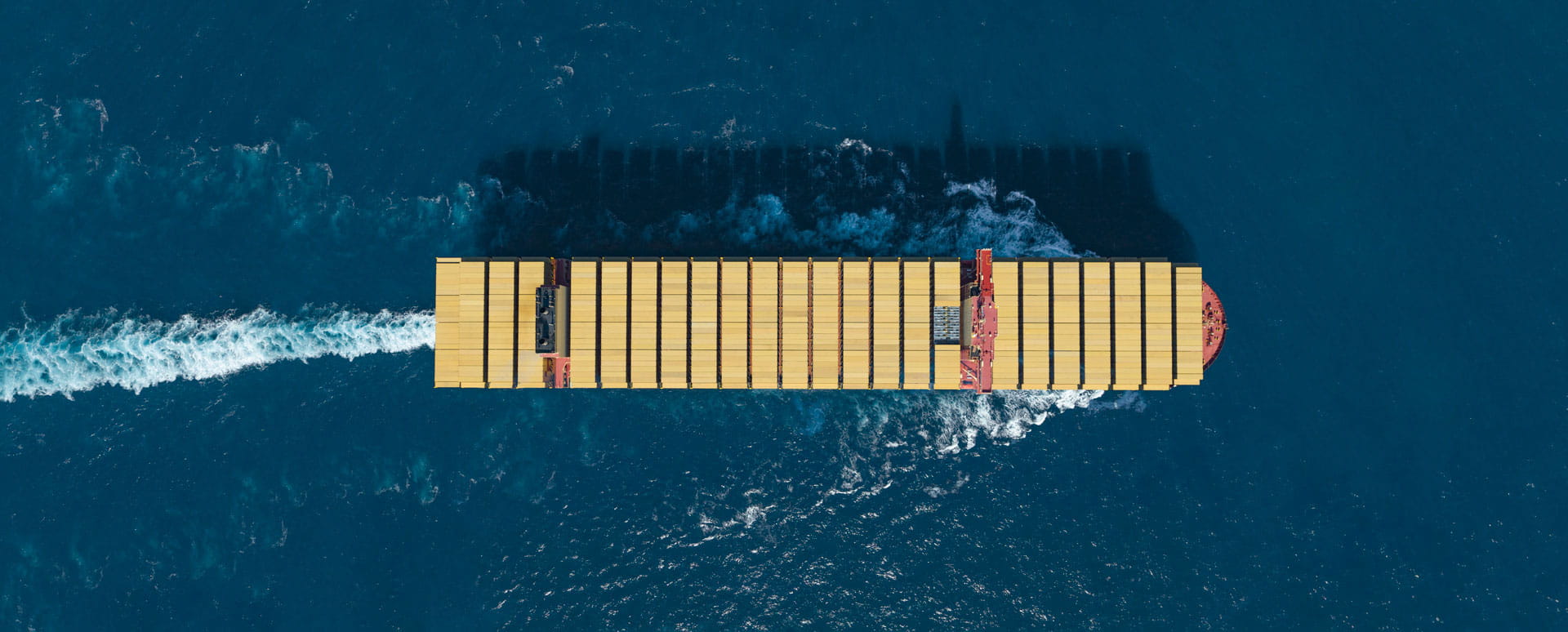 MSC Container Vessel view from the top carrying MSC yellow containers while sailing in deep blue sea